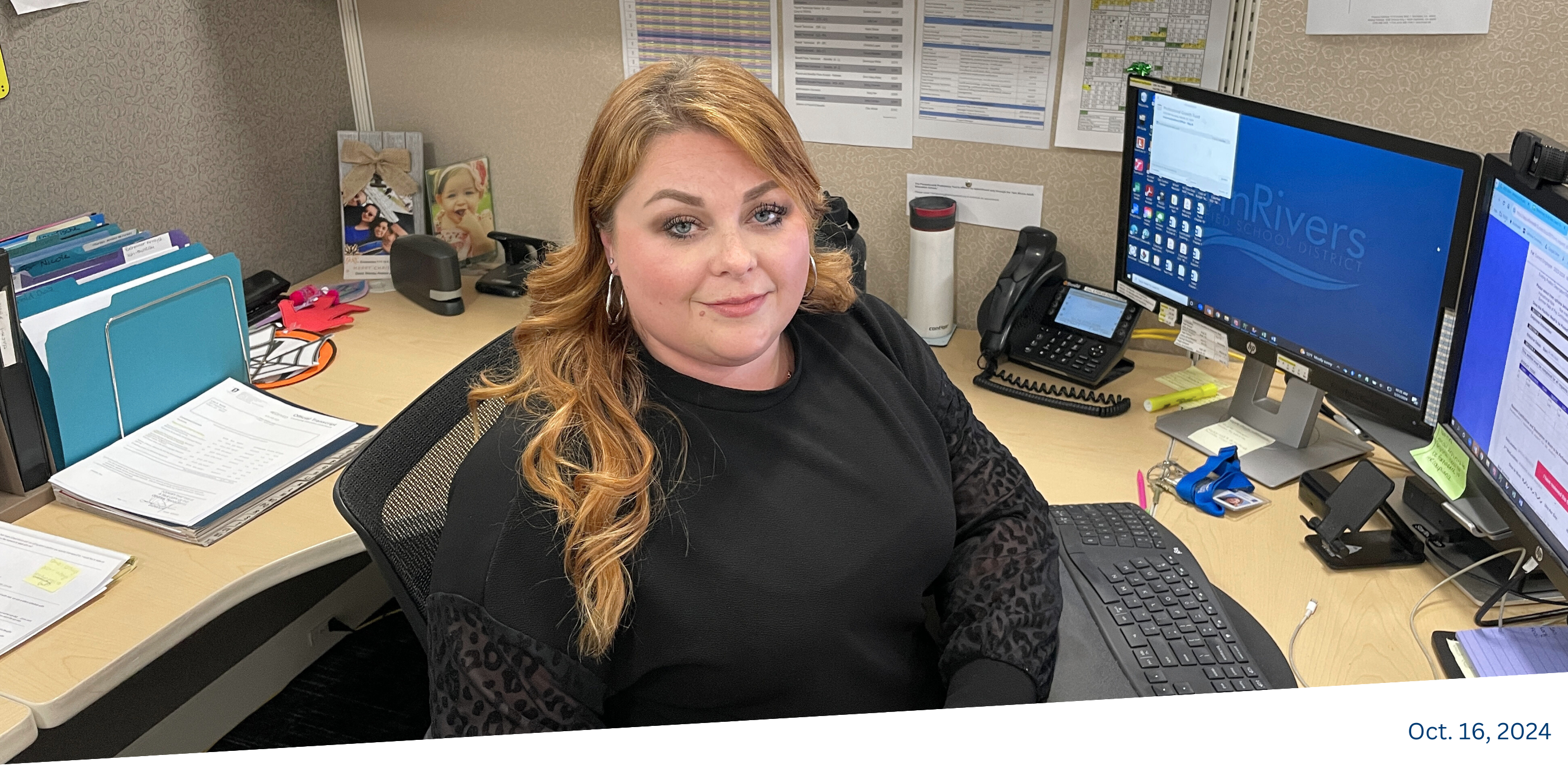 woman sitting at office desk looking into the camera