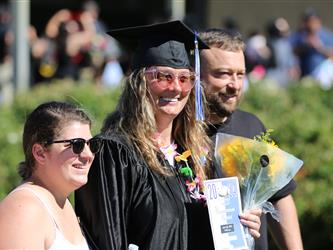 graduates celebrating and smiling at their graduation ceremony