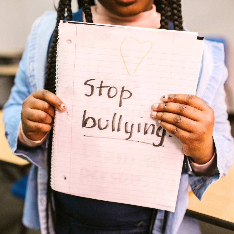 stop bullying girl holding sign